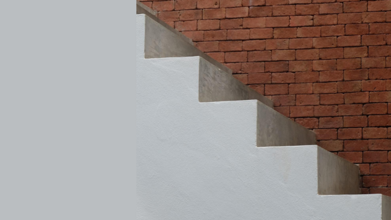 graue Stufen, seitlich eine braune Backsteinmauer